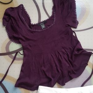 Edged in purple lamé with back tie. Made of viscos